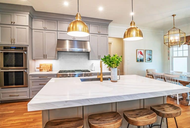 Gold pendant lights over a kitchen island
